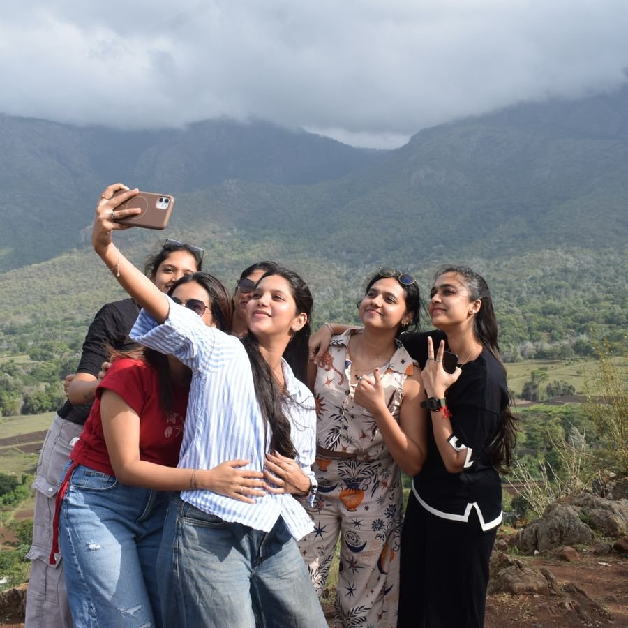 Friends taking a selfie on a hillside