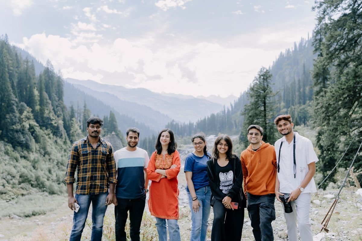 A group of friends standing together in a mountain valley