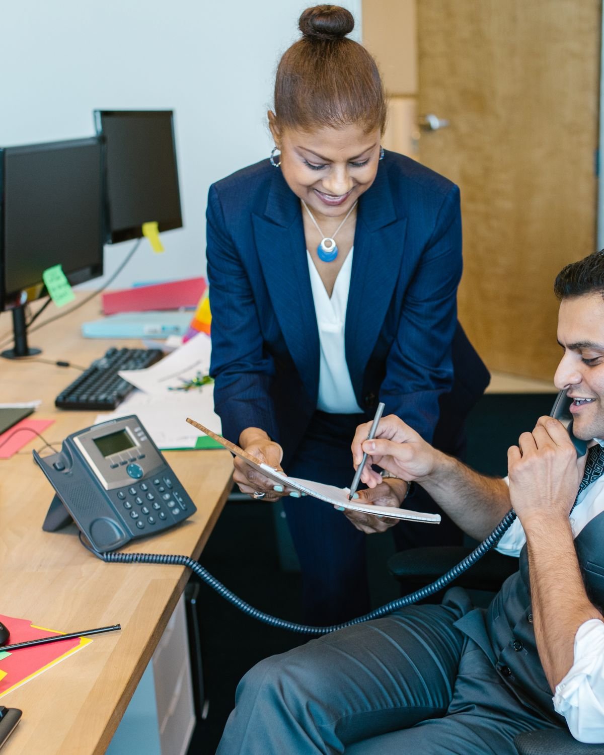 A Plannex travel consultant on the phone with a customer