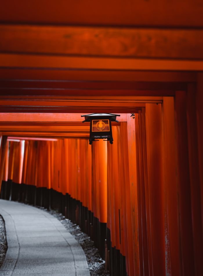 Corridor of red torii gates at a Japanese shrine